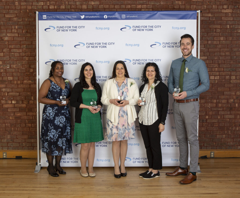 Five of the seven 2022 Sloan Teaching Award recipients holding their crystal apple trophies; Shanua Newton-Rodriguez, Francesca DiPietro, Elisa Margarita, Amanda Valenti, Jeff Hamilton
